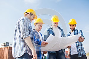 Group of builders with tablet pc and blueprint