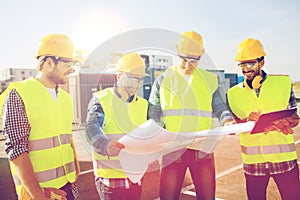 Group of builders with tablet pc and blueprint