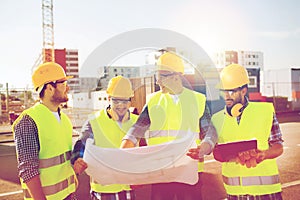 Group of builders with tablet pc and blueprint