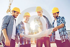 Group of builders with tablet pc and blueprint