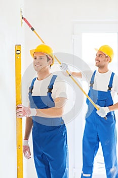 Group of builders with tools indoors