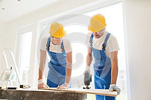 Group of builders with tools indoors