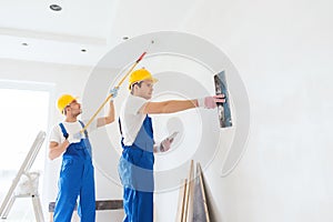 Group of builders with tools indoors