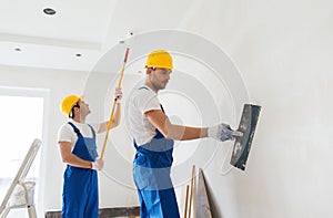 Group of builders with tools indoors