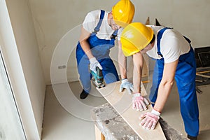 Group of builders with tools indoors