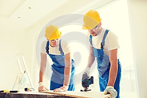 Group of builders with tools indoors