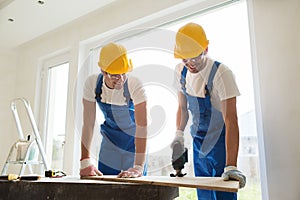 Group of builders with tools indoors