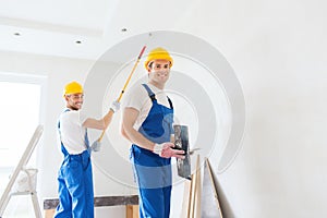 Group of builders with tools indoors