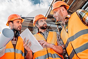 group of builders using digital tablet