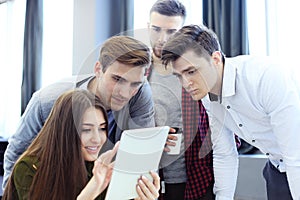 Group of buisness people working on tablet.