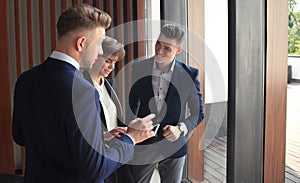 Group of buisness people working on tablet.