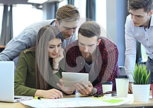 Group of buisness people working on tablet.