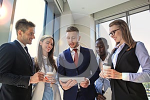 Group of buisness people working on tablet.