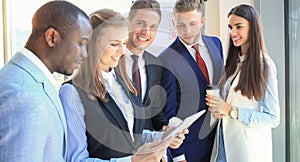 Group of buisness people working on tablet.