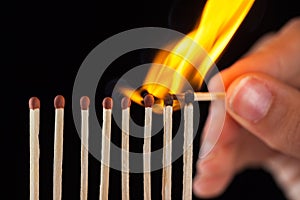 Group of burn and unburned matches, on black background