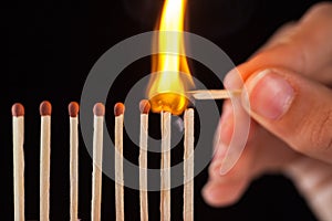 Group of burn and unburned matches, on black background