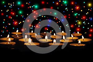 Group of burning candles on black background