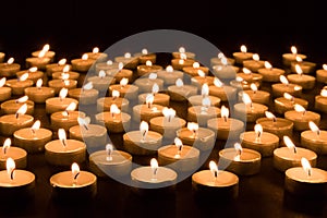 Group of burning candles at a black background