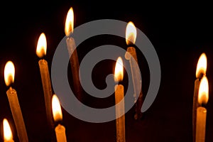 Group of burning candles in dark