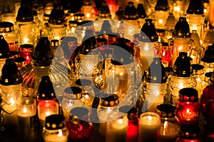 Group of burning grave candles during Polish All Saints` Day at cemetery.