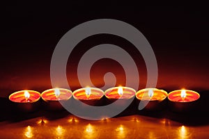 Group of burning red tealight candles