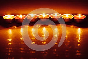 Group of burning red tealight candles