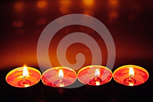 Group of burning red tealight candles