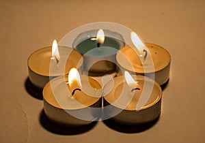 Group of burning small candles on a white background.