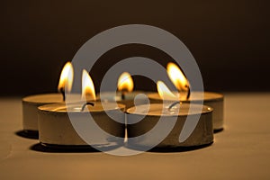 Group of burning small candles on a white background.