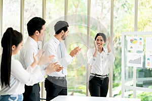 Group of Business applauding while in a meeting at modern office