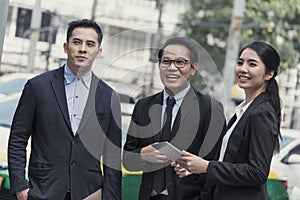 Group of business asian partner discussing while walking in office building. colleague social concept