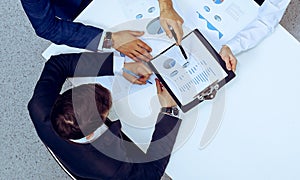 Group of business people analyzing financial documents, view from above. Business team at meeting