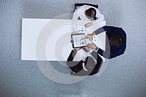 Group of business people analyzing financial documents, view from above. Business team at meeting