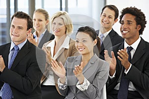 Group Of Business People Applauding Speaker At The End Of A Pres