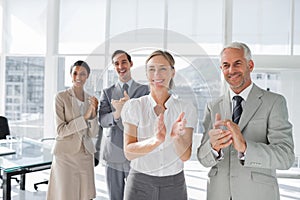 Group of business people applauding together