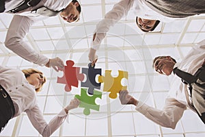 Group of Business People Assembling Jigsaw Puzzle.