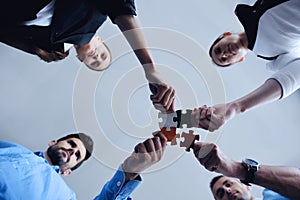 Group of business people assembling jigsaw puzzle