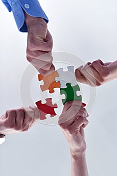 Group of business people assembling jigsaw puzzle