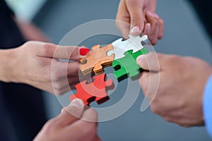 Group of business people assembling jigsaw puzzle