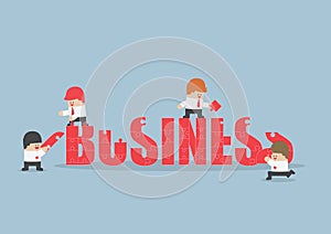 Group of business people assembling jigsaw puzzle of business word