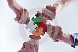 Group of business people assembling jigsaw puzzle