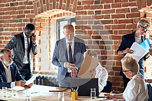 Group of business people brainstorming together in meeting room