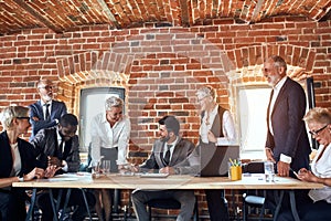 Group of business people brainstorming together in meeting room