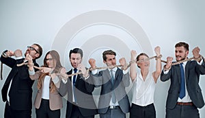 Group of business people breaking a strong rope