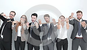 Group of business people breaking a strong rope