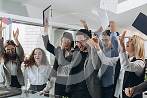 Group of business people celebrating by throwing their business papers and documents fly in air, Power of cooperation, Success