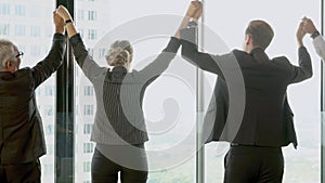 Group of business people cheerful rejoice with achievement raise hand