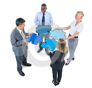 Group of Business People Connecting Jigsaw Puzzles