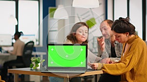 Group of business people discussing company plan with mockup laptop