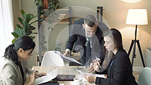 Group business people discussing income charts and graphs at the meeting in modern office.